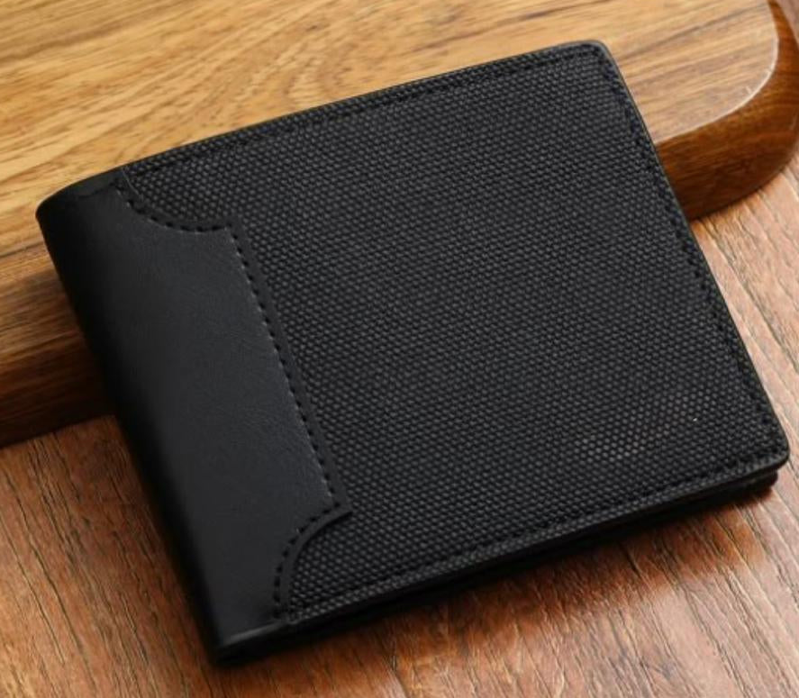 Black wallet on a wooden surface